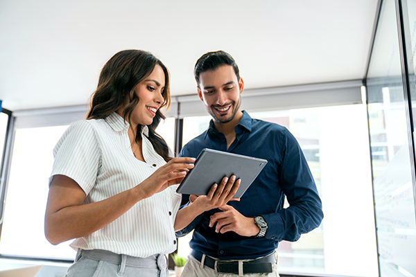 Business people sharing ideas at the office while using a digital tablet